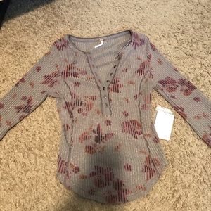 Free People gray top with floral details and buttons.